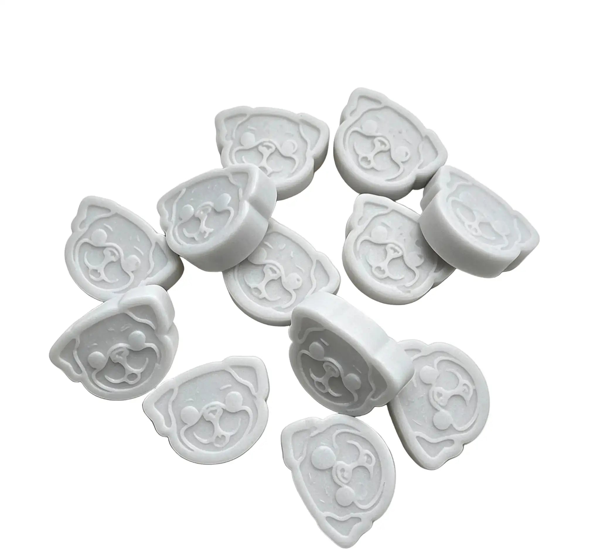 A set of white wax melts cutters shaped like cartoon dog faces, arranged on a plain white background.