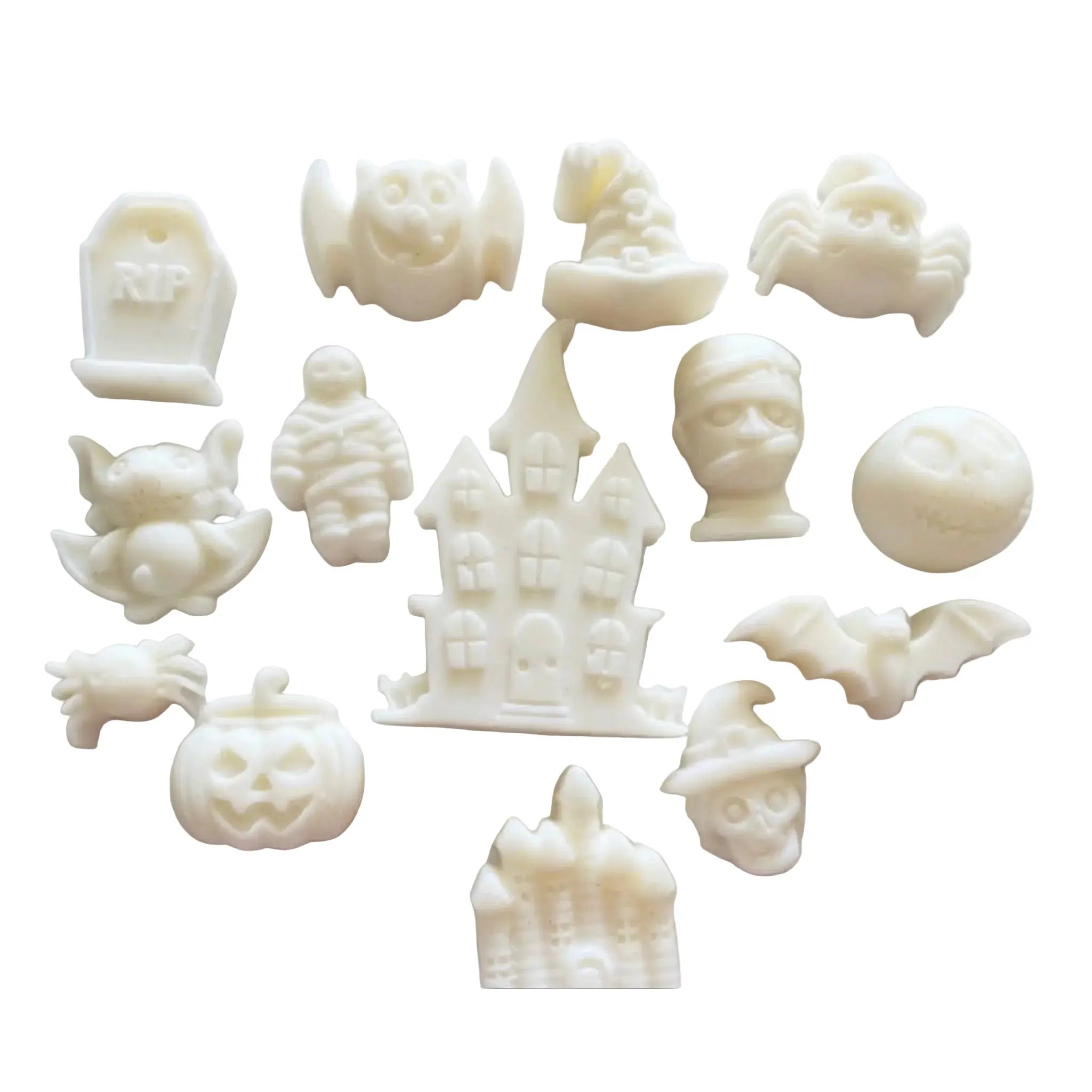 A set of small white Halloween-themed WAX MELT  or charms arranged on a plain white background, including a haunted house, pumpkins, bats, a mummy, a tombstone, a witch hat, a spider, and a skull.