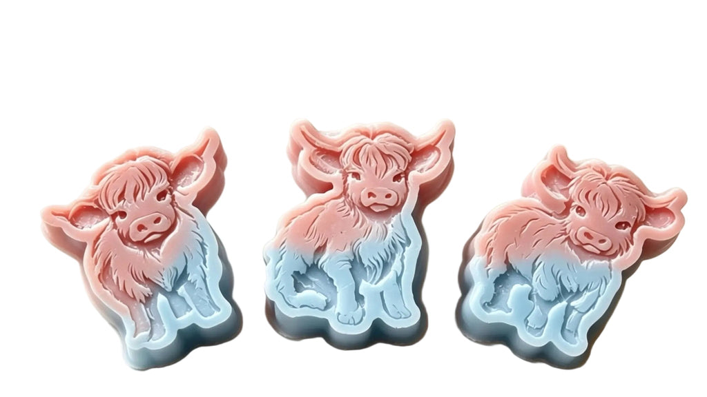 Three cow-shaped wax melts  in a pink-to-blue gradient, displayed on a light beige surface with a text overlay detailing measurements and holding weight.
