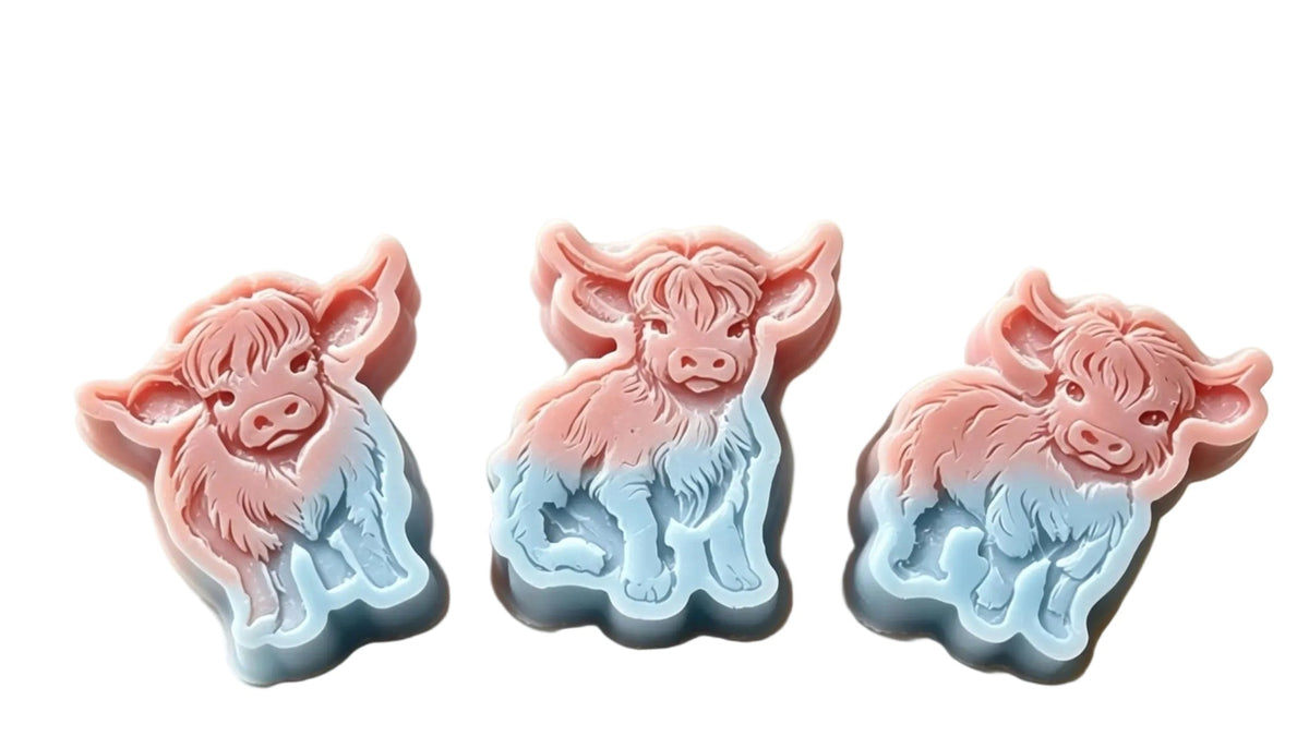 Three cow-shaped wax melts  in a pink-to-blue gradient, displayed on a light beige surface with a text overlay detailing measurements and holding weight.