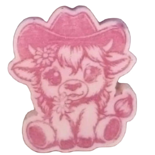 A pink WAX MELTS featuring a cartoon cowgirl calf design, shown on a textured brown surface.