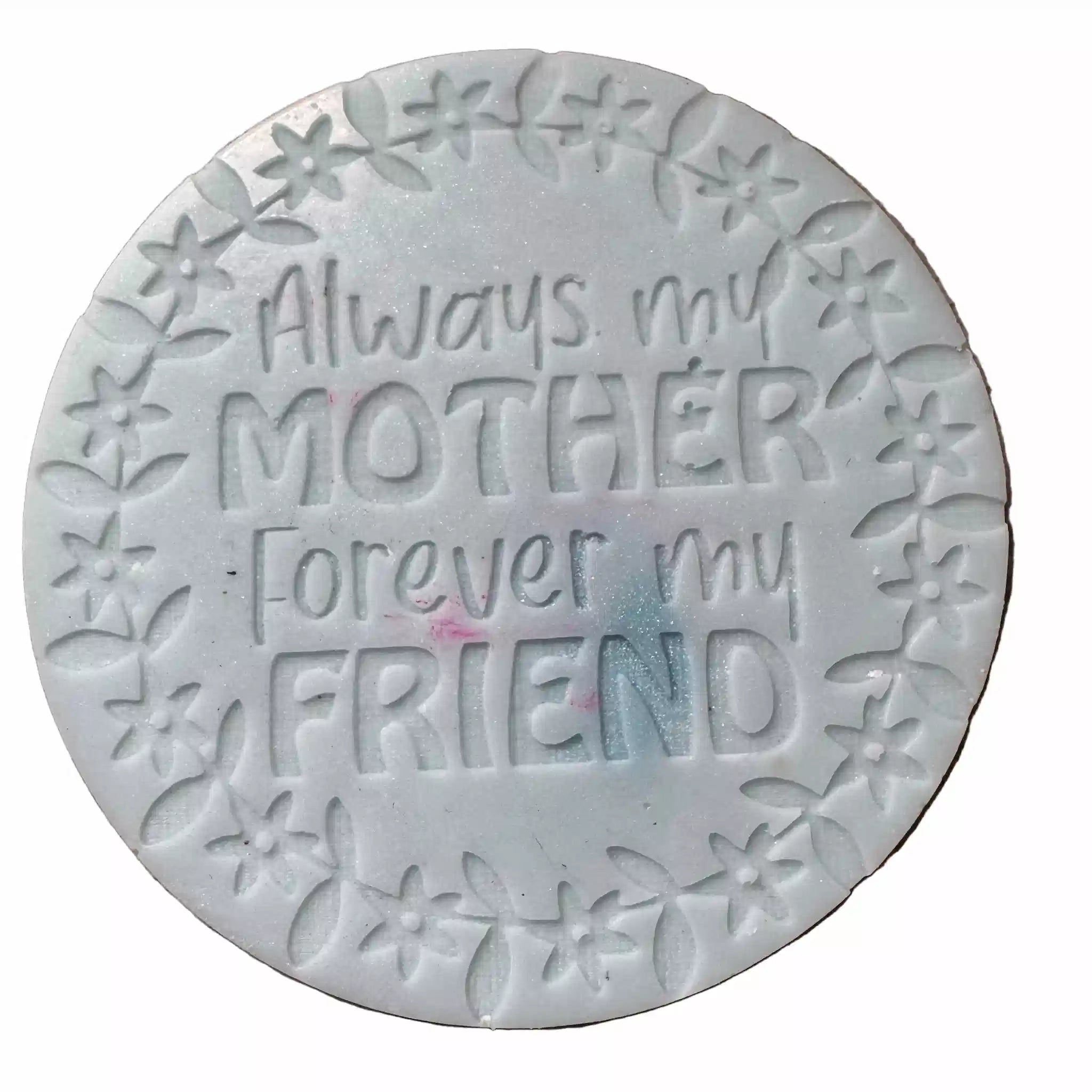A round white decorative wax melt embossed text 'Always my MOTHER Forever my FRIEND' surrounded by a floral border, shown on a plain white background.