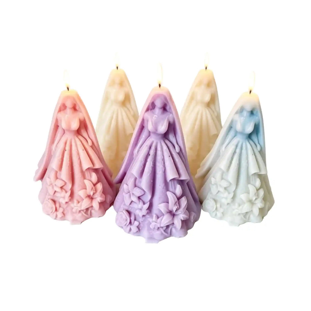 Four bride figurine candles in pastel colors, including pink, lavender, cream, and light blue, arranged against a plain white background.