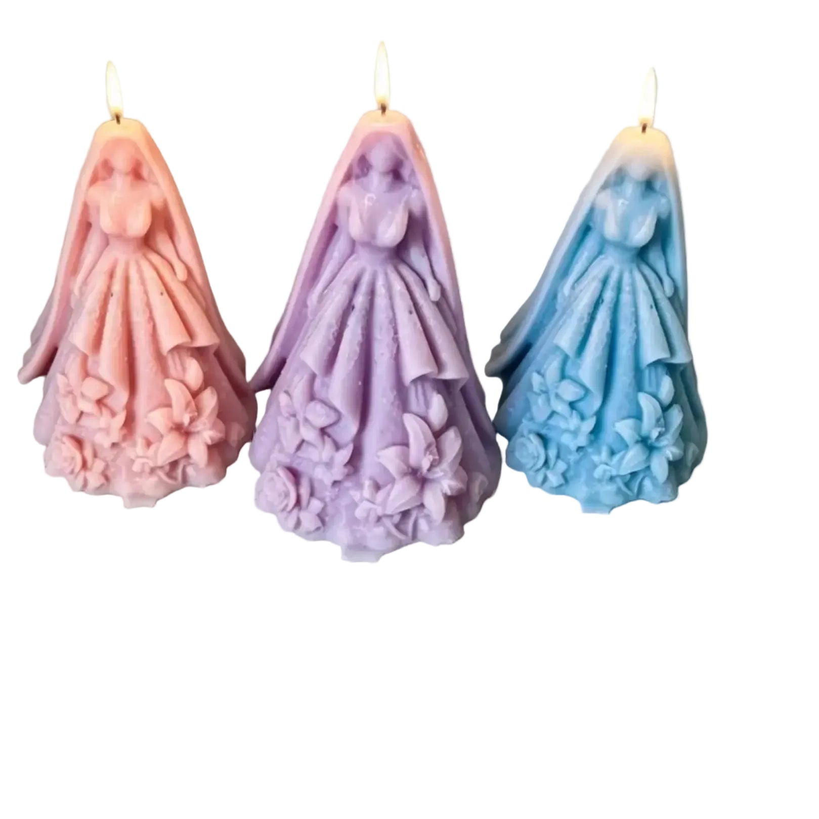 Three wedding-themed pillar candles shaped like bride and groom, shown in pink, purple, and blue, with lit flames against a solid gray background.