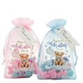 Two sheer mesh favor bags, one pink and one light blue, each containing baby wa melt items and a printed teddy bear gift tag with a 'Thank you' ribbon, on a white background.