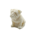 A small white CANDLE of a bulldog sitting down, photographed on a seamless white background.