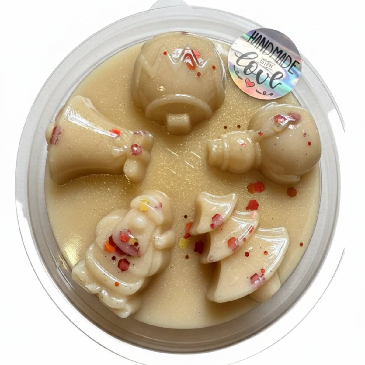Handmade wax melt with angel design in clear packaging on a wooden surface