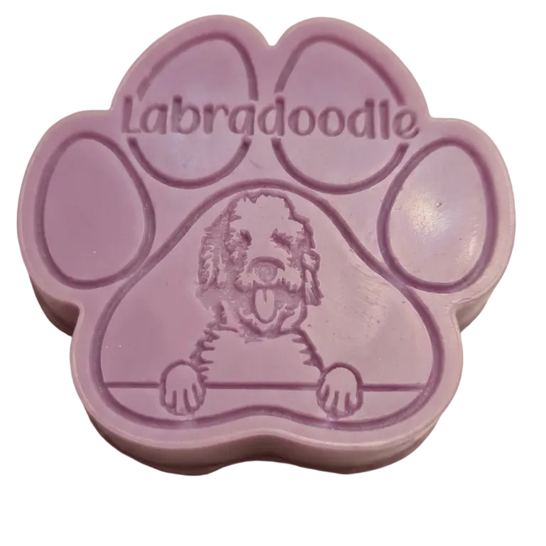 A lavender purple paw print shaped wax melt, likely a soap bar or stamp, featuring an embossed cartoon Labrador dog and the word 'Labradoodle' across the top, shown on a plain white background.