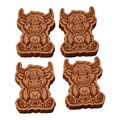 Four cartoon-style brown cow-shaped wax melts arranged in a 2x2 grid on a white and gray checkered background. Each cow cookie holds a small teddy bear with a heart on its chest.