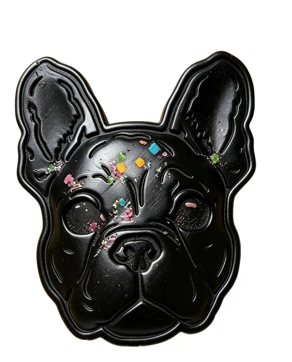 A black French Bulldog-shaped tray or mold decorated with colorful glitter and small flower-like embellishments, shown against a plain white background.