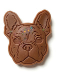 Chocolate mold shaped like a dog's face on a white background