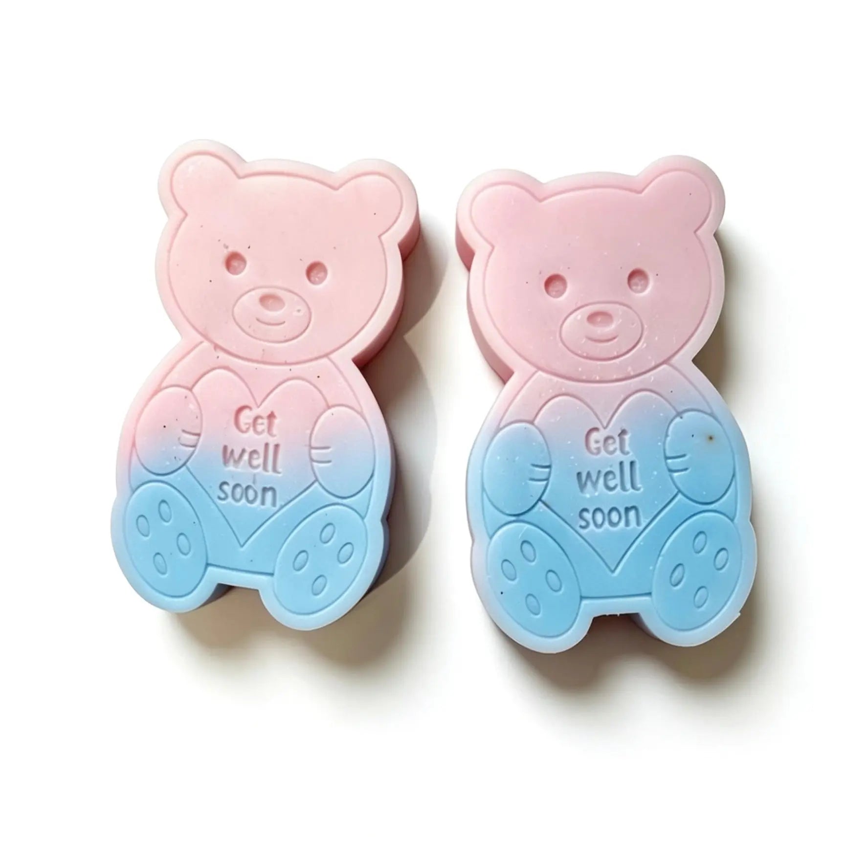 Two teddy bear-shaped baby TEDDY SHAPED WAX MELT  in a pink-to-blue gradient, featuring an embossed heart with the words 'Get well soon' on a white background.