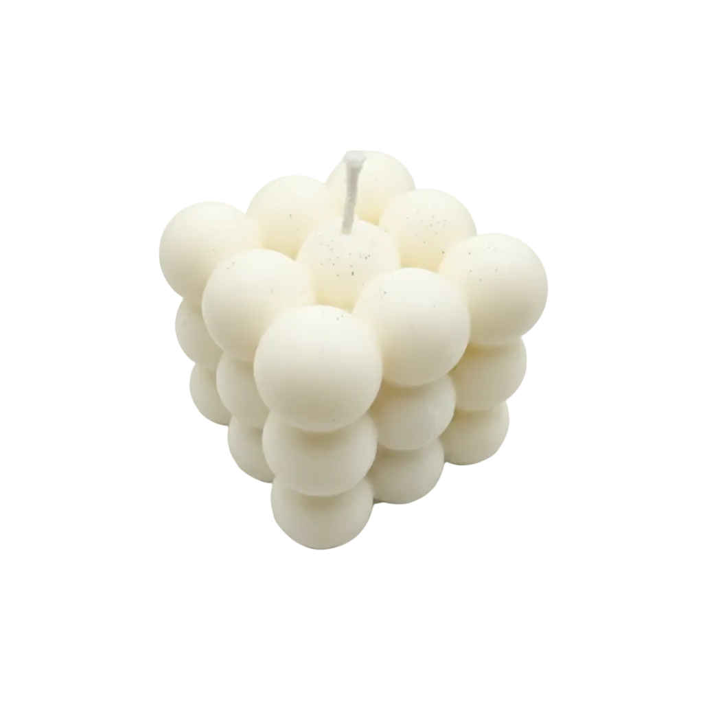 A cluster-style candle made of rounded, bubble-like segments in an off-white or cream tone, photographed on a plain light background. A small 'Dola AI' watermark appears in the bottom-right corner.