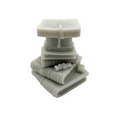 A small gray sculptural Wax Candle  figurine depicting a stack of books with a graduation cap and tassel, photographed on a seamless white background.