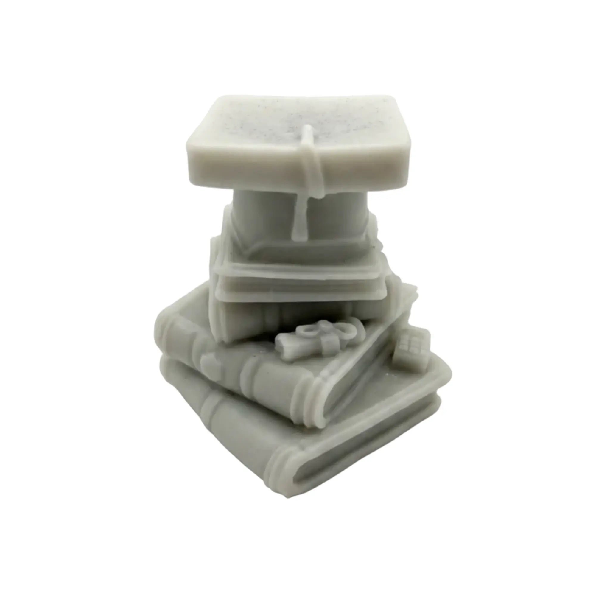 A small light gray sculpted figurine or WAX MELT CANDLE like a stack of books with a square top, photographed on a plain white background.