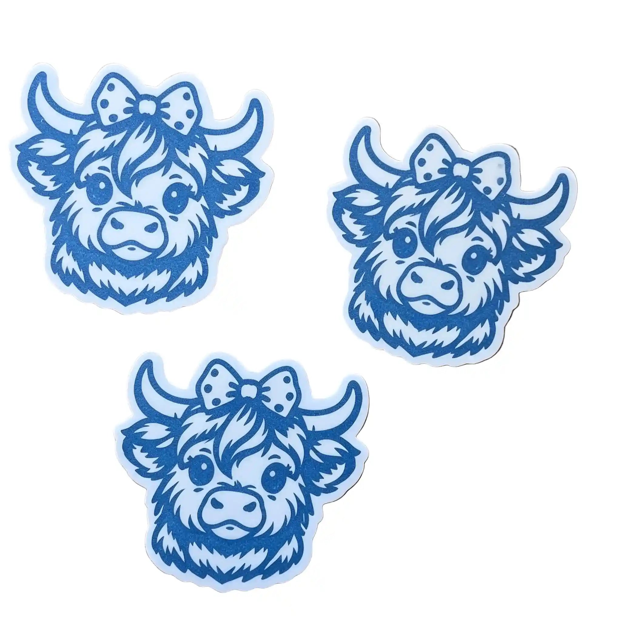 Three blue cartoon Highland cow wax melts with bows, arranged on a plain white background.