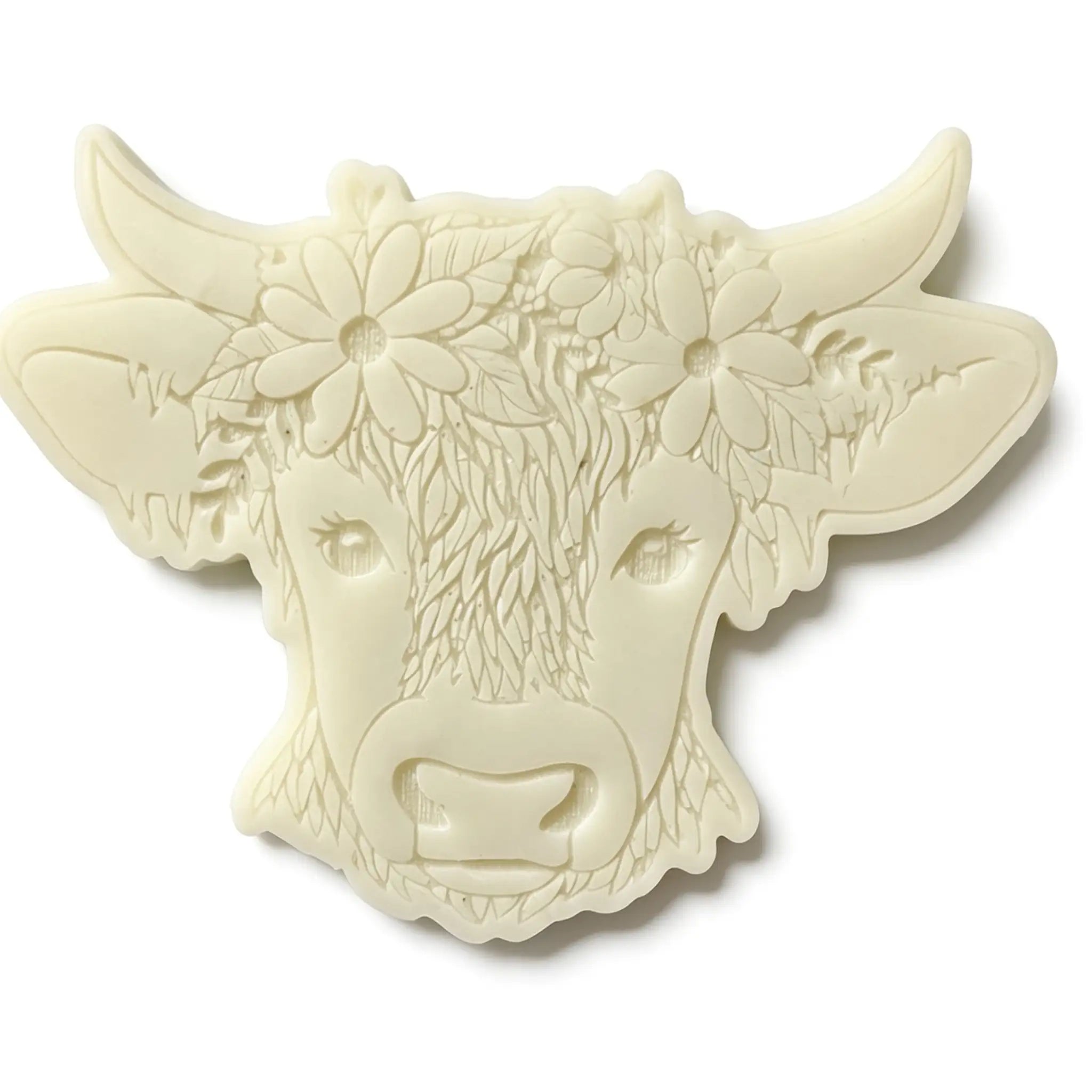 An off-white decorative cow head plaque featuring embossed floral details on its forehead and ears, shown against a plain white background. wax melt