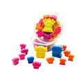 A set of small colorful character-shaped plastic toys or charms displayed on a white background, with several pieces scattered in front and a clear round container holding more pieces behind them. wax melts scoopies