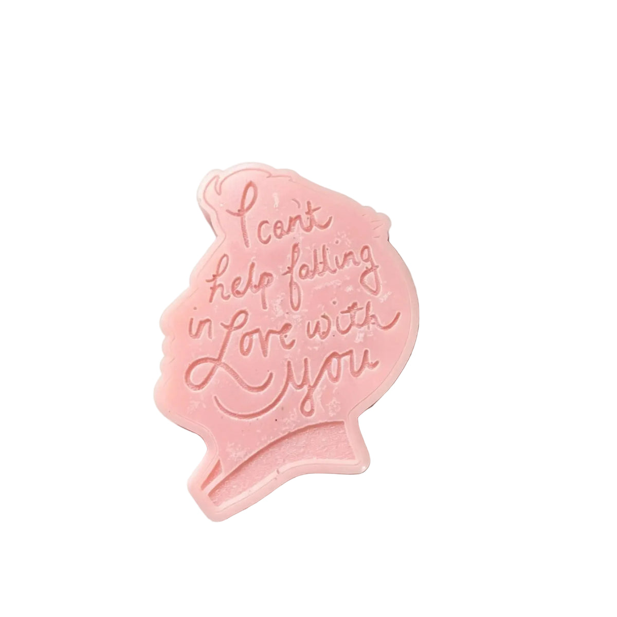 A light pink swax melt  like a pregnant silhouette, featuring the embossed text 'I can't help feeling in love with you' in a cursive font, set against a plain white background.