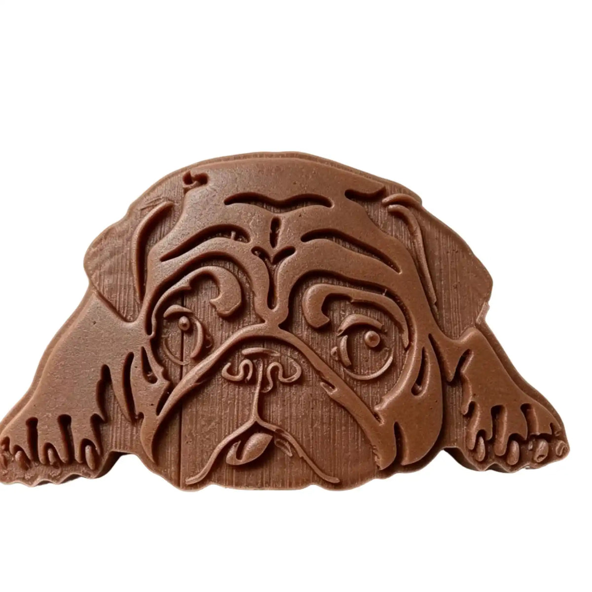 A brown pug-shaped wax melt item with carved facial details, shown on a plain white background.