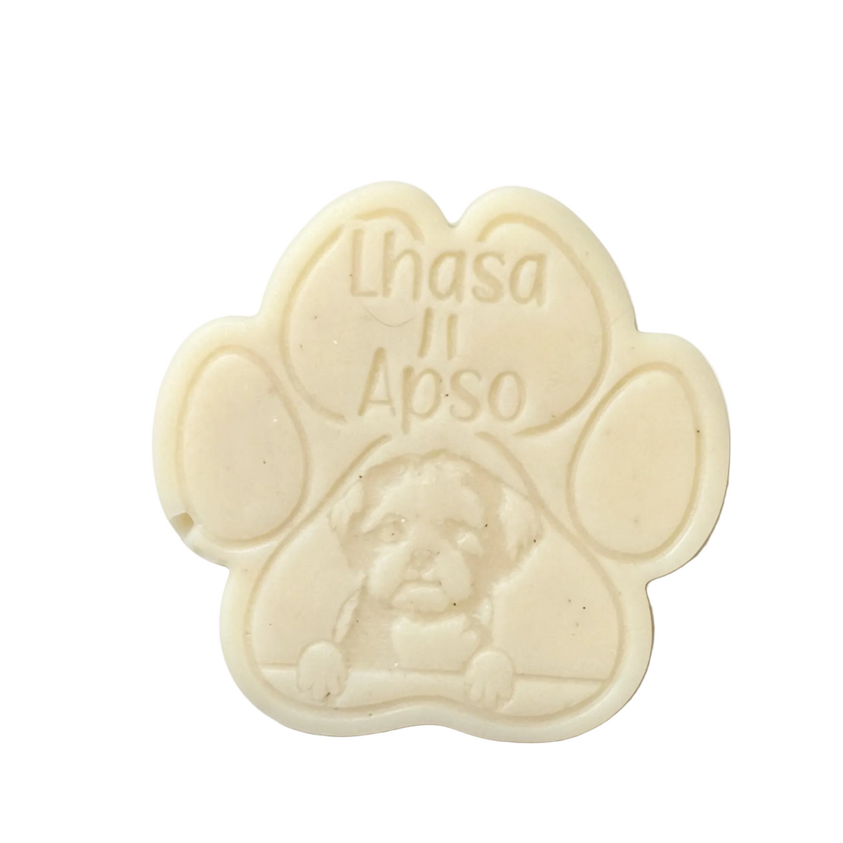 A custom cream-colored paw print wax melt  featuring the embossed text 'Lhasa Apso' and a small portrait of a Lhasa Apso dog, photographed on a clean white background.