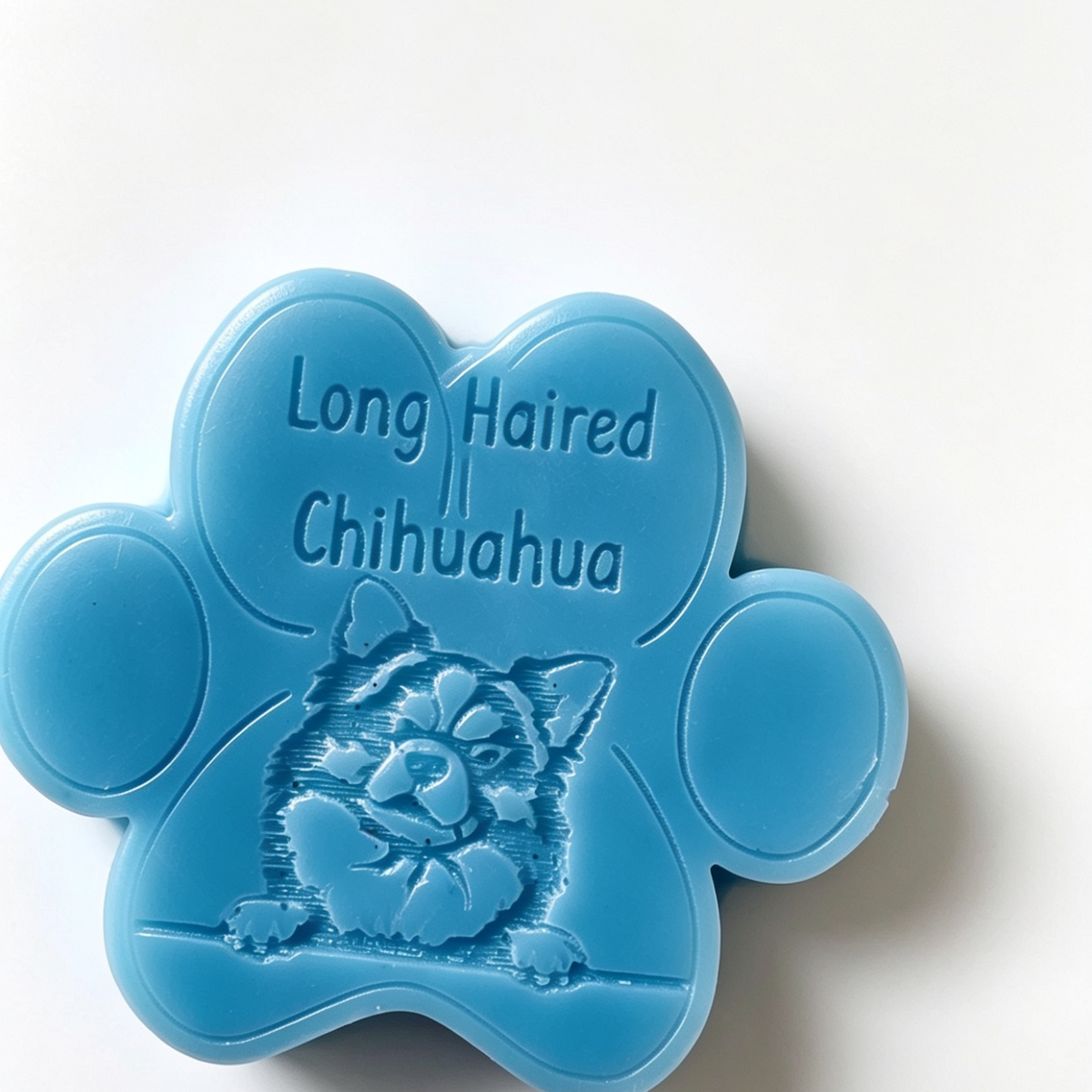 A light blue paw-shaped Wax Melt featuring an embossed Chihuahua dog illustration and the text 'Long Haired Chihuahua' on a plain white background.