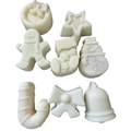 Seven WAX MELT pieces shaped like holiday motifs, including a crescent moon, star, gingerbread person, stocking, snowman, candy cane, bow, and bell, arranged on a plain white background.