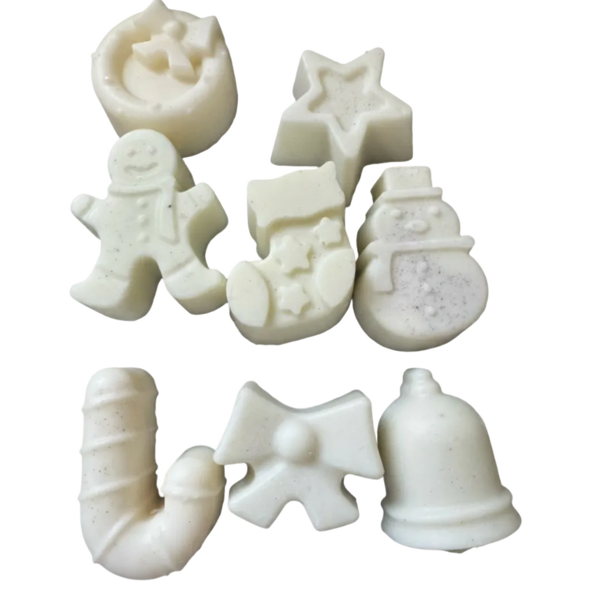 Seven WAX MELT pieces shaped like holiday motifs, including a crescent moon, star, gingerbread person, stocking, snowman, candy cane, bow, and bell, arranged on a plain white background.