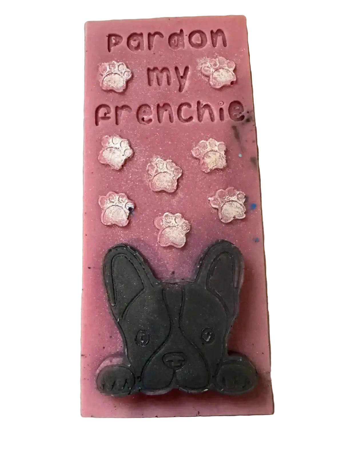 A pink rectangular  WAX SNAP bar with the words 'pardon my frenchie' raised in the top section, decorated with small pink paw prints and a large black French Bulldog face at the bottom, photographed on a speckled countertop.