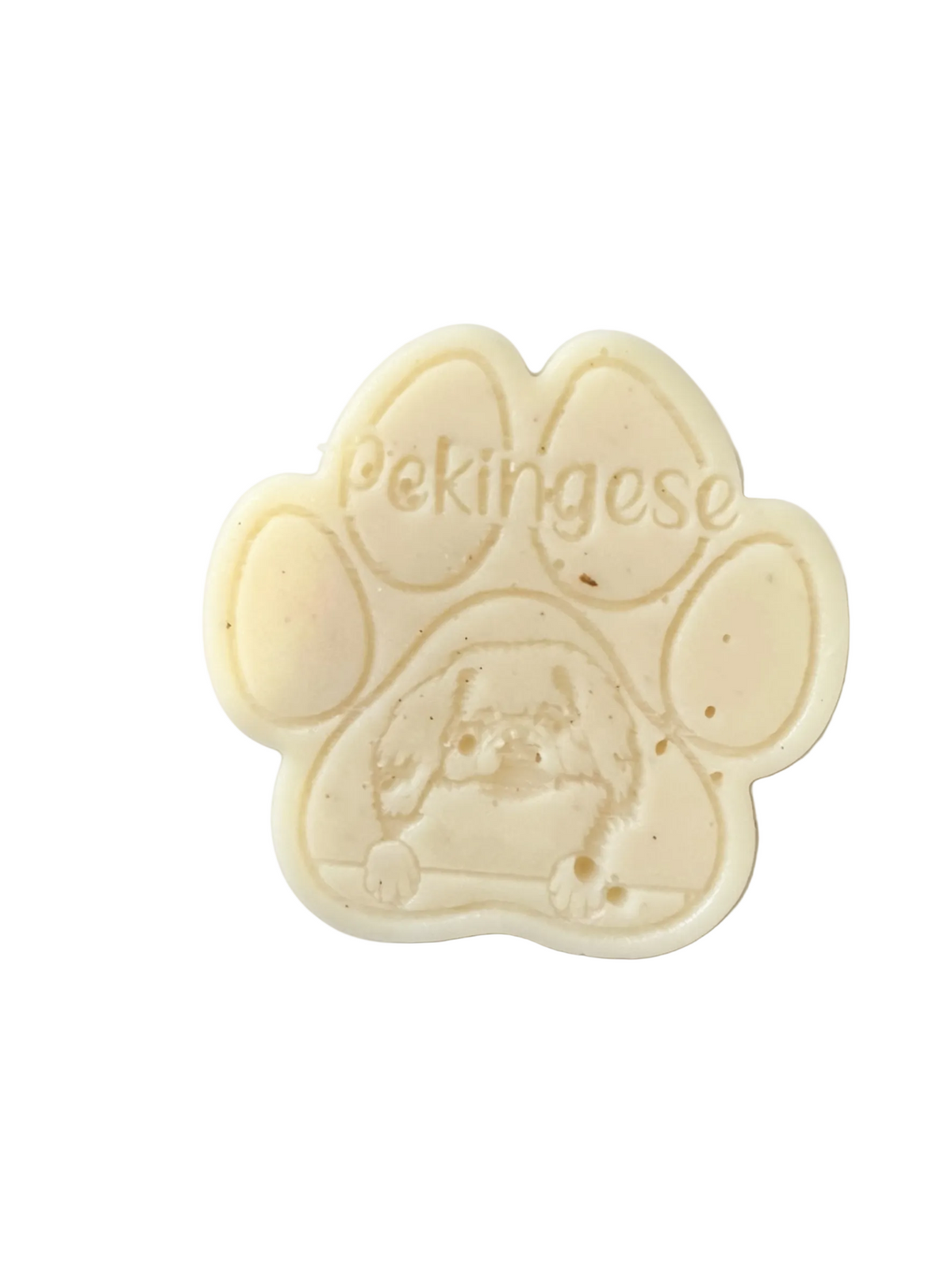 A paw-shaped cream-colored  Pekingese featuring an embossed Pekingese dog illustration and the text 'Pekingese' across the top, photographed on a clean white background.