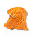 An orange 3D-printed pug-shaped sticker or charm with glittery orange wax melt and the text 'Pugs & Kisses' at the bottom, shown on a plain white background.