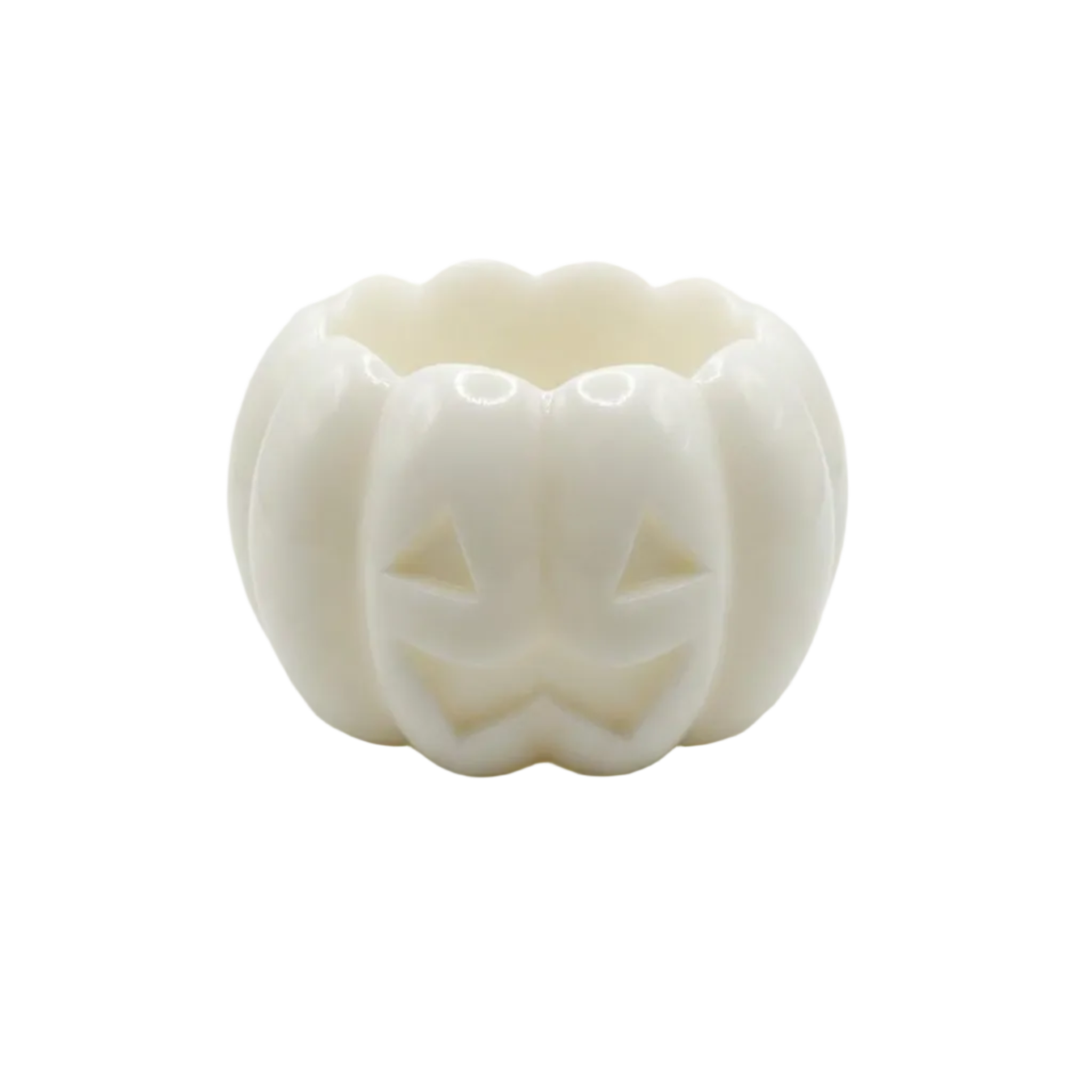 A white pumpkin-shaped  candle holding made of wax with a carved jack-o'-lantern face, photographed on a seamless white background.