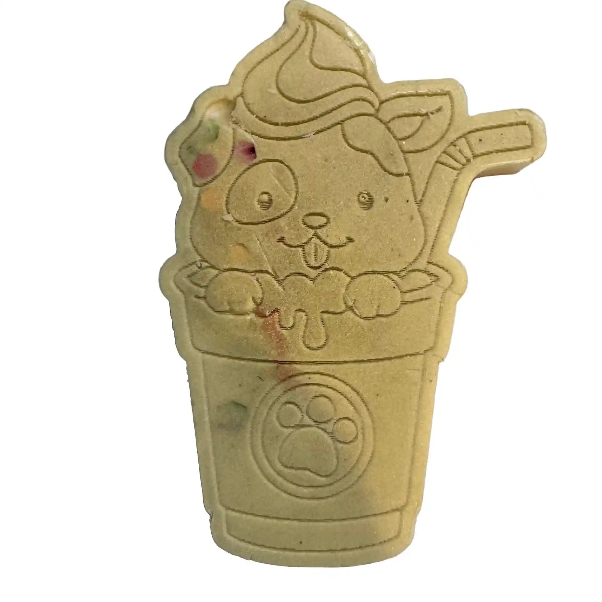 A beige pet grooming lick mat shaped like a cartoon cat in a cup of ice cream, featuring a paw print emblem on the cup, set against a plain white background. wax melt