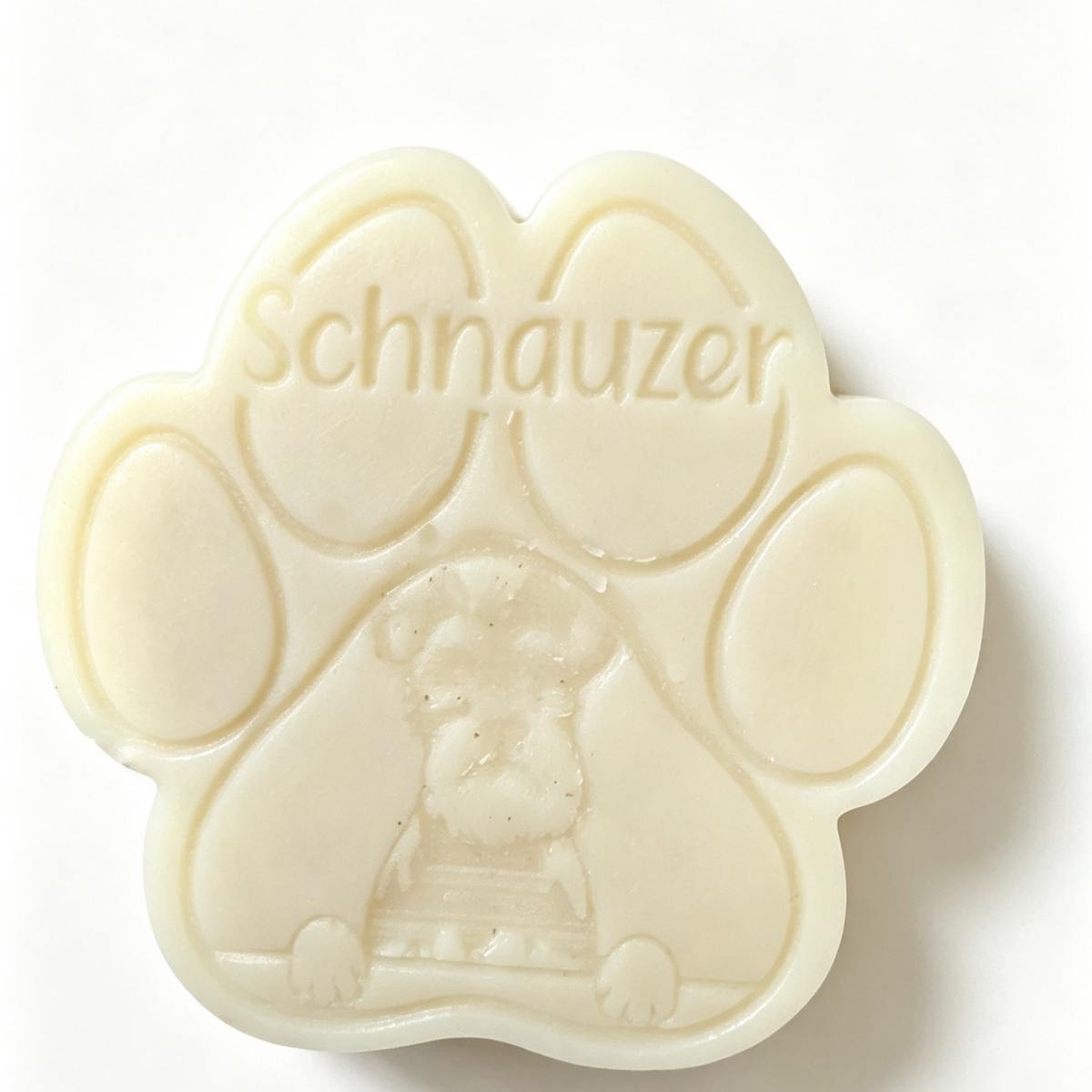 An off-white paw-shaped Wax Melt featuring an embossed Schnauzer dog illustration and the word 'Schnauzer' molded across the top, set against a plain white background.