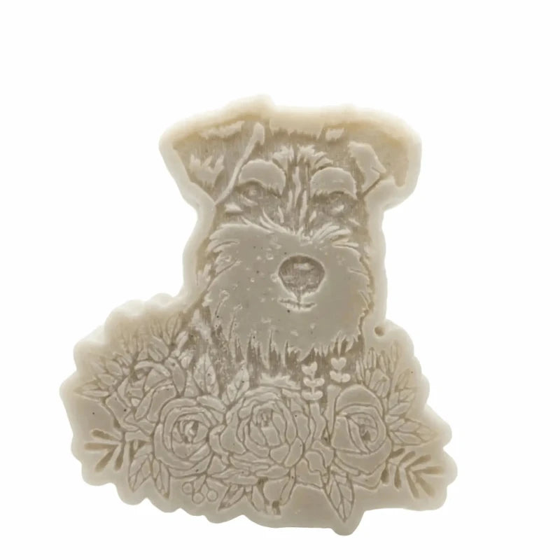An off-white silicone mold or wax melt featuring an embossed portrait of a terrier dog with roses at the bottom, shown on a plain white background.