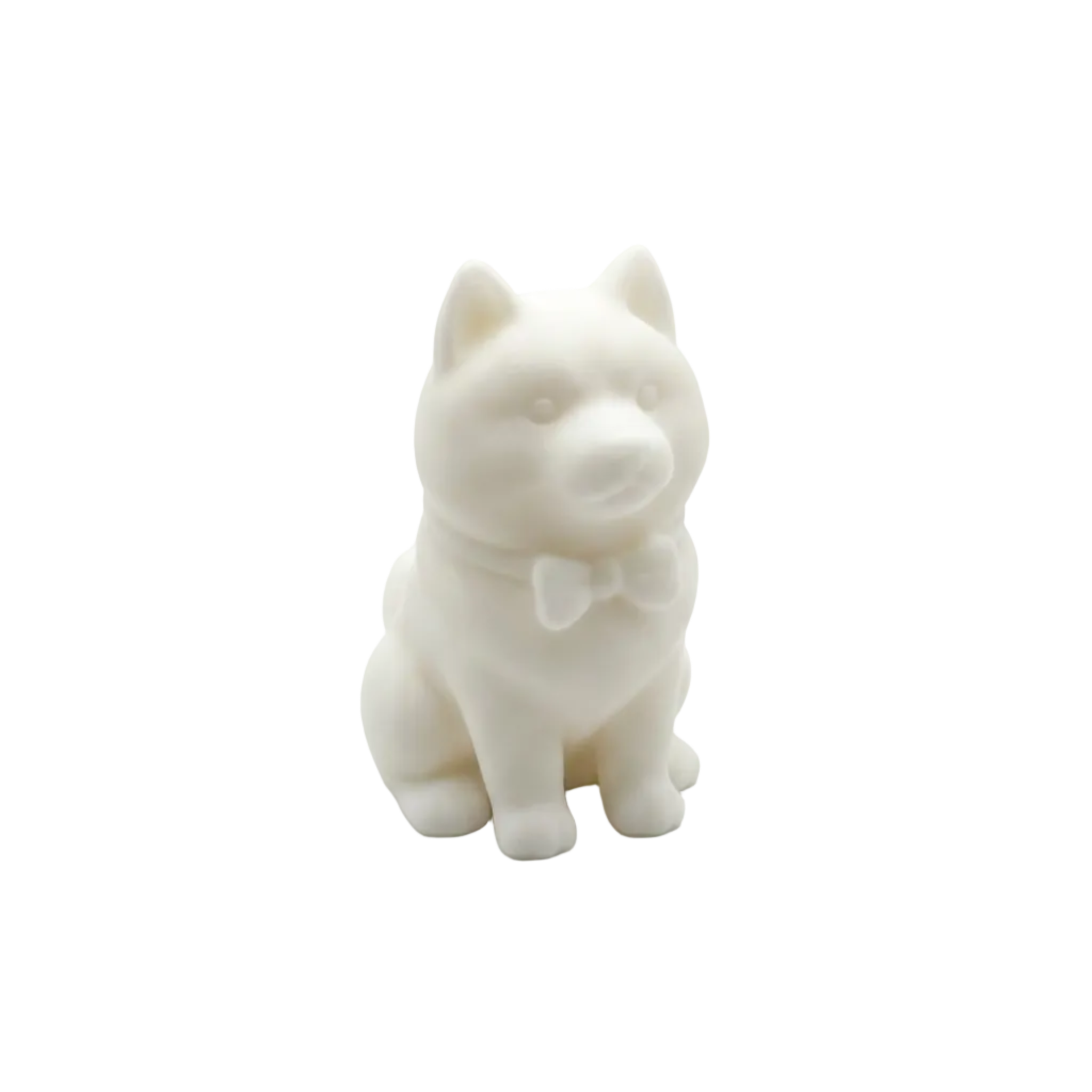 A small white CANDLE of a sitting husky dog with a bow tie HUSKY, centered on a seamless white background.