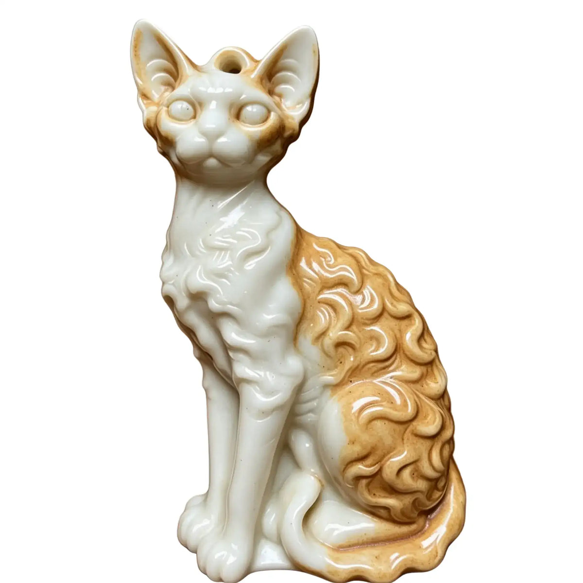 A ceramic figurine of a curly-haired cat, likely a Sphynx wax melt , in a sitting position. The cat features a glossy white body with warm tan and cream highlights on its ears, face, and curly fur.