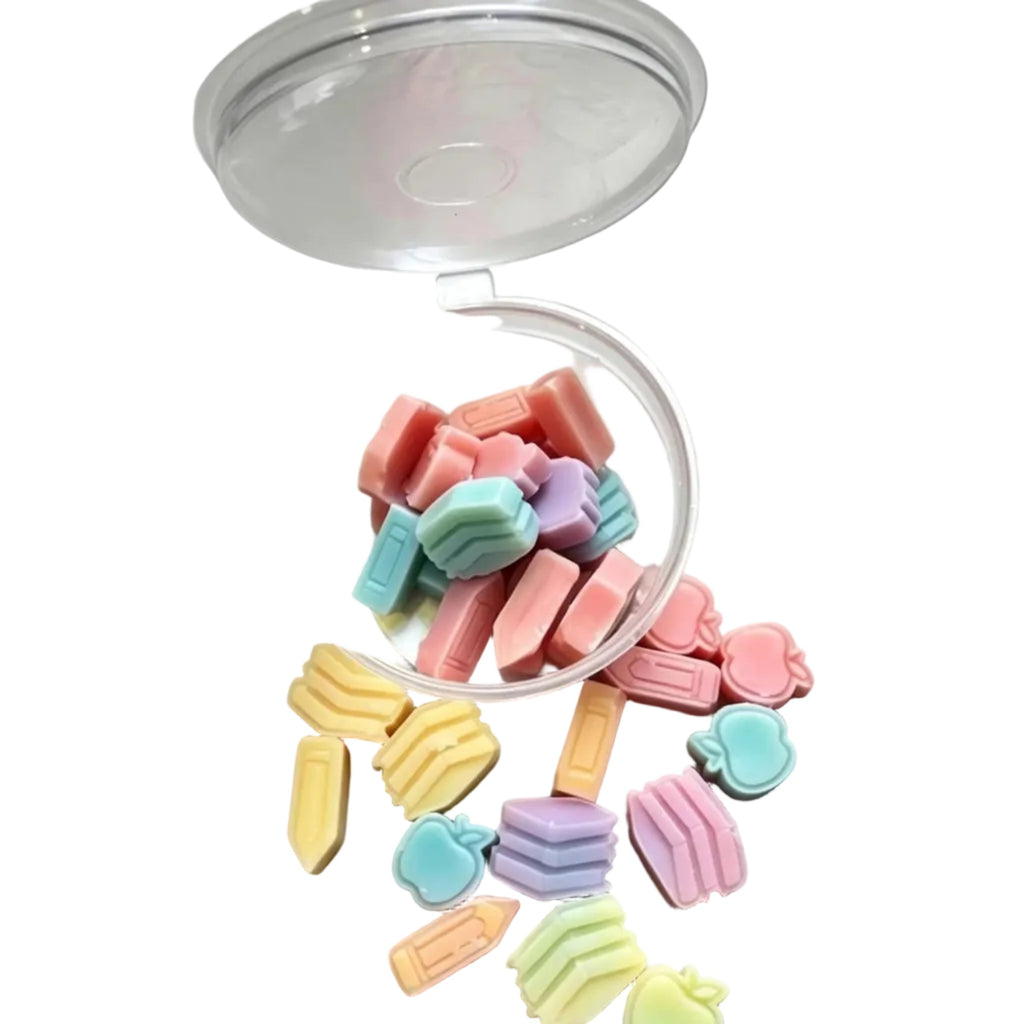 A clear plastic cup tipped over on a white surface,
like animals and flowers in soft pastel colors including pink, blue, green, yellow, and lavender. scoopies wax melts 