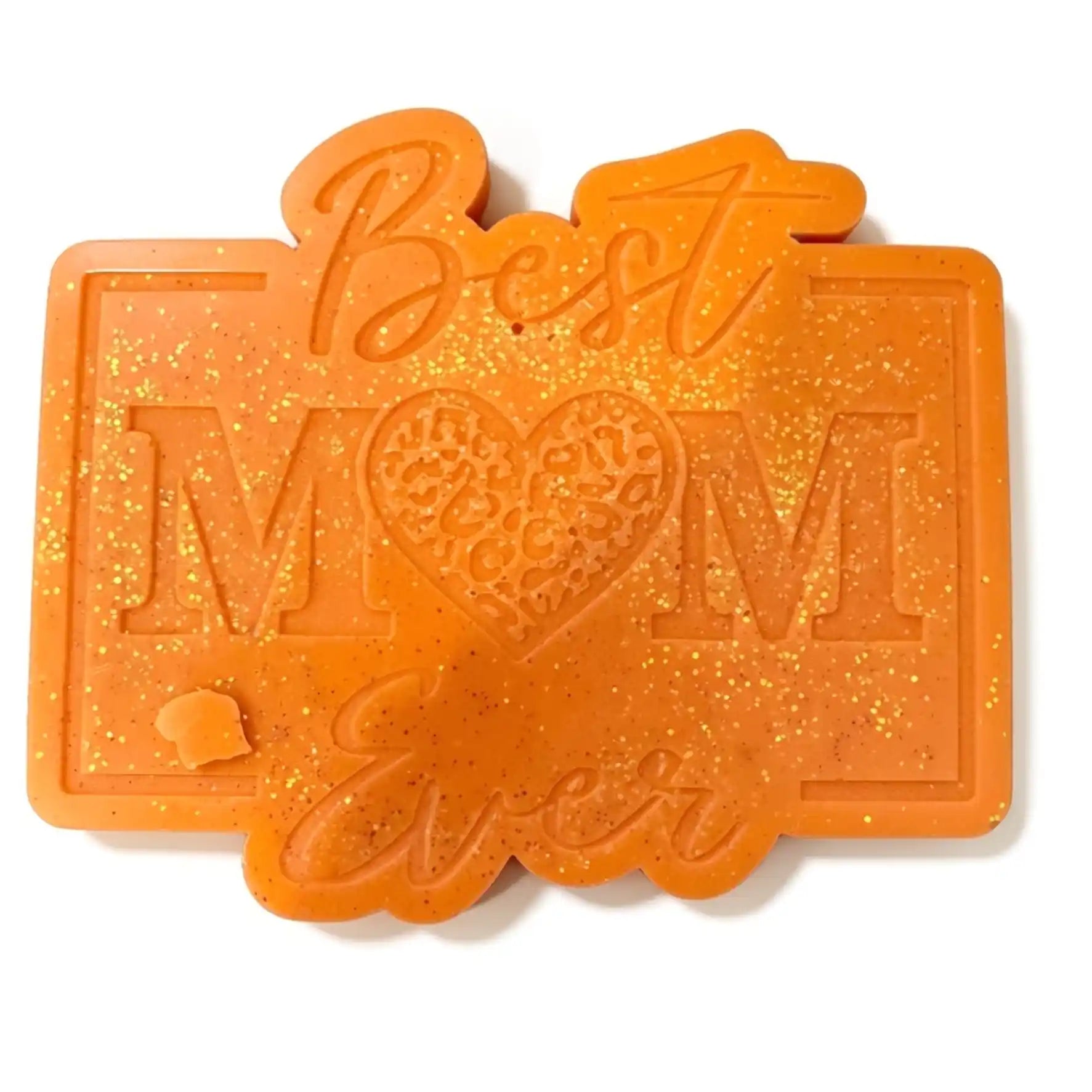An orange glittery resin wax melt with 'Best Mom Ever' embossed in the center, featuring a heart-shaped cutout with a leopard print pattern, on a white background.