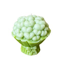 A novelty candle shaped like a bouquet of light green, bubble-textured flowers with a small white wick, set against a plain white background.