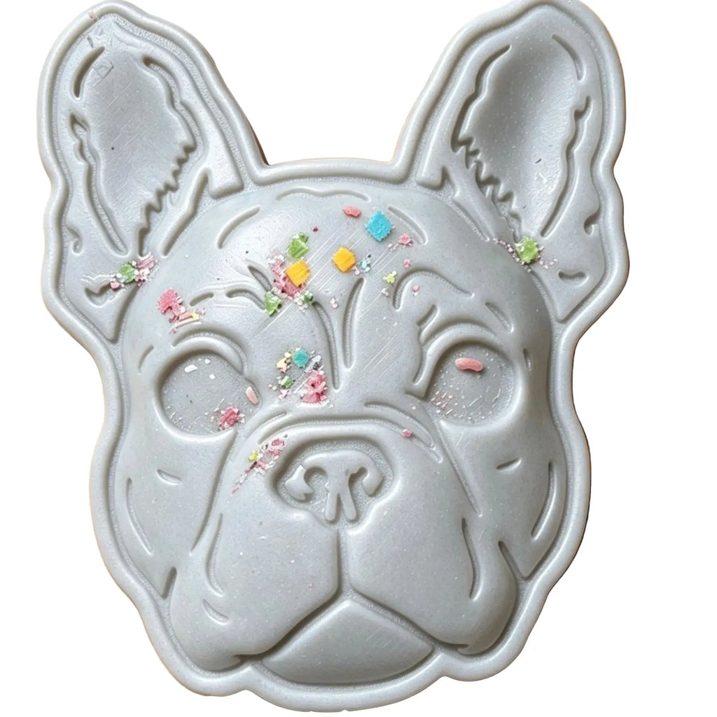 A light gray French Bulldog-shaped soap decorated with small multicolored glittery confetti pieces, shown on a plain white background.